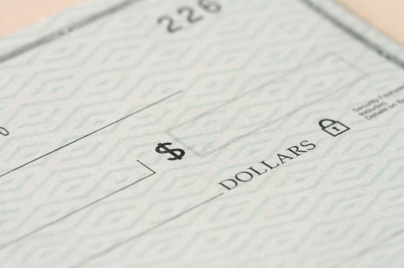 Close-up of a paper check showing the dollar amount field